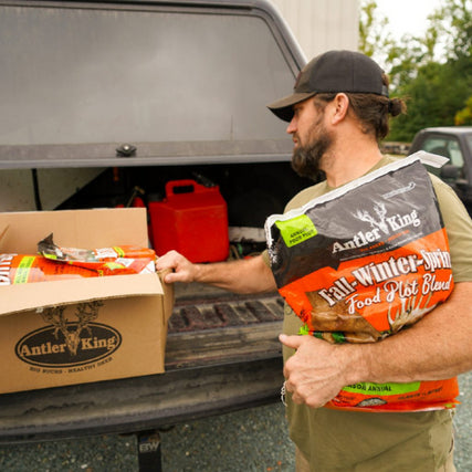Deer Feed/Food PlotsA close-up of placing deer feed in a truck bed